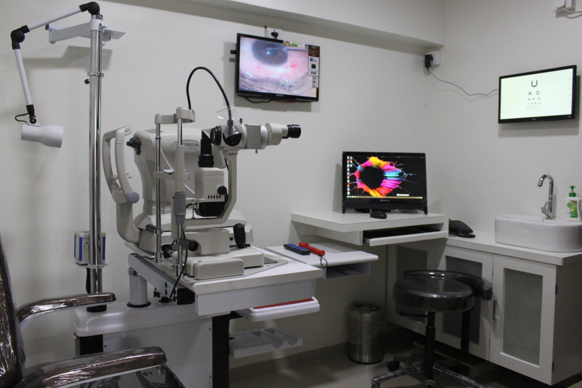Topcon slit-lamp paired with a Lenovo all-in-one corneal topography mapping station inside an Insight Institute diagnostic suite